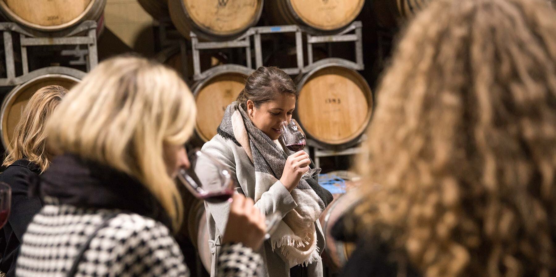 Wine Tasting Around Wine Barrels